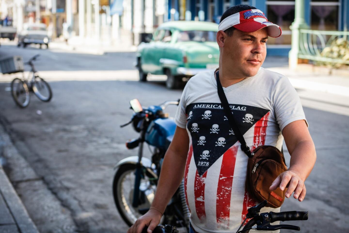 A man wears a T-shirt in the colors of the United States flag in a street of Guantanamo, Cuba, some 27 km from Guantanamo Naval Base, on March 12, 2016.