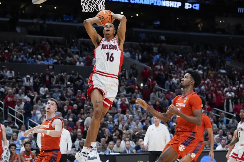 Arizona forward Keshad Johnson (16) dunks during the first half of a Sweet 16 college basketball game against Clemson in the NCAA tournament Thursday, March 28, 2024, in Los Angeles. (AP Photo/Ryan Sun)