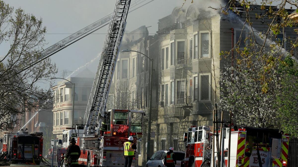 Firefighters battle an apartment fire Monday morning in Oakland.