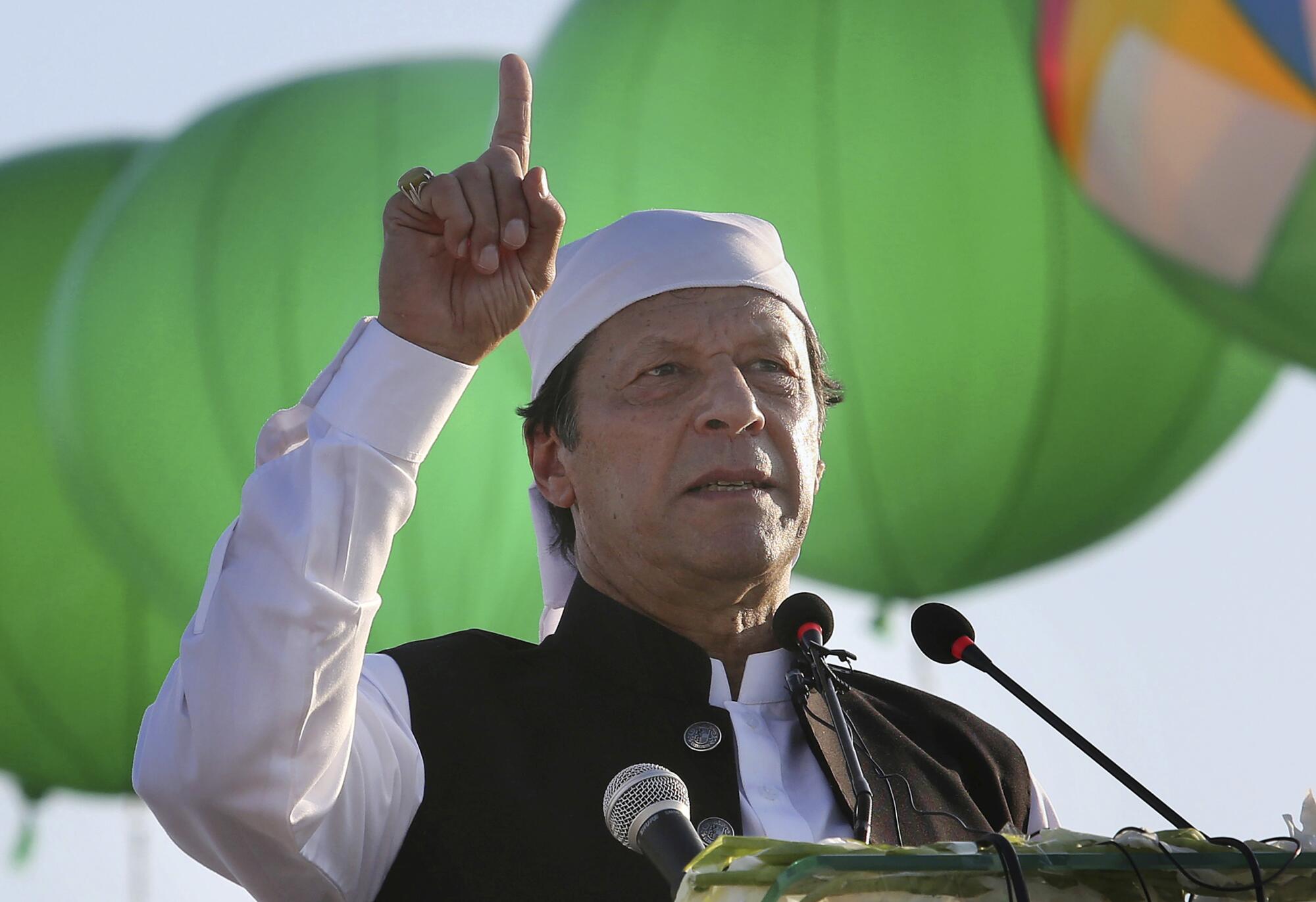 Pakistani Prime Minister Imran Khan raises a finger during his address. 