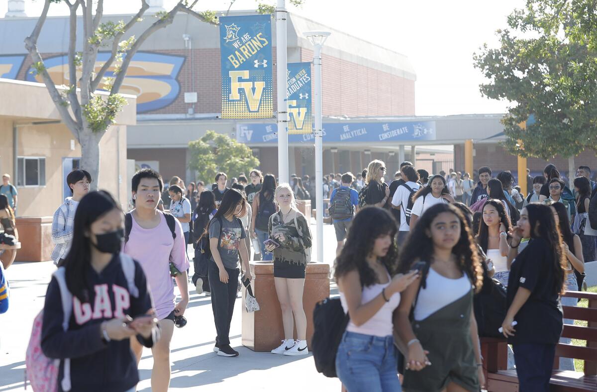 Students crowd the quad as they walk to class on the first day of the school year at Fountain Valley High on Wednesday.