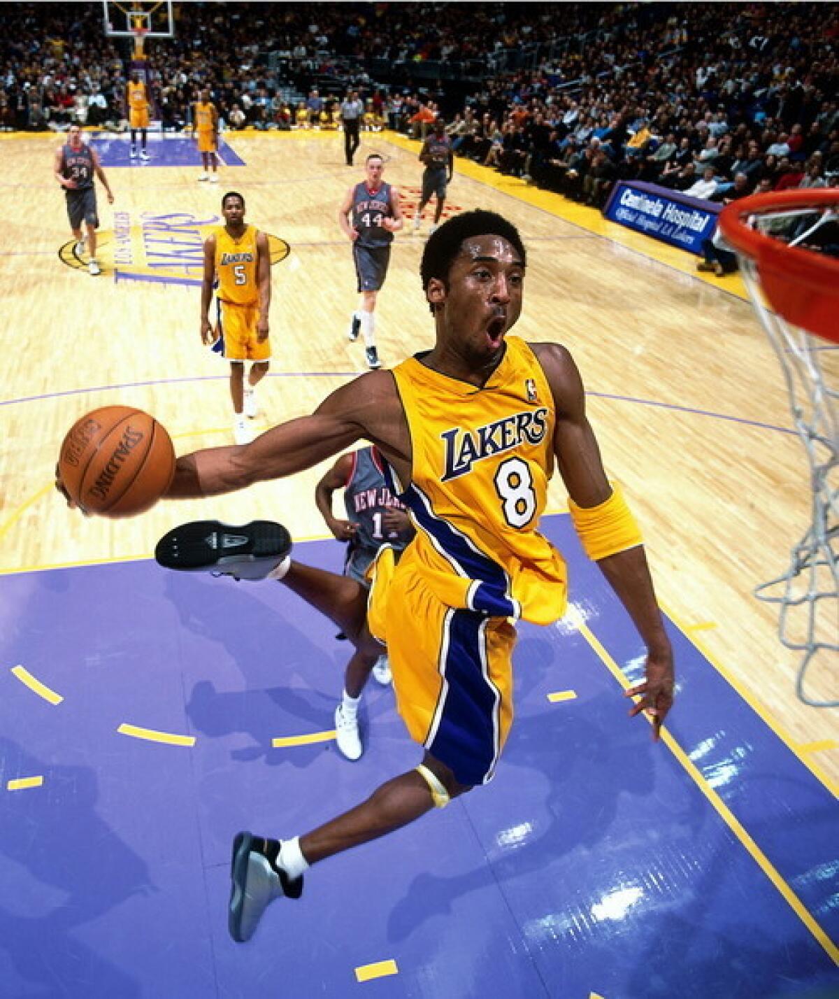 Kobe Bryant goes in for a slam dunk against the Nets during a 2001 NBA game.