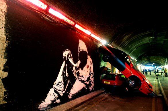 A work by British graffiti artist known as Banksy is seen in an abandoned access road in London. Banksy brought together many different graffiti artists for the graffiti show, called The Cans Festival.