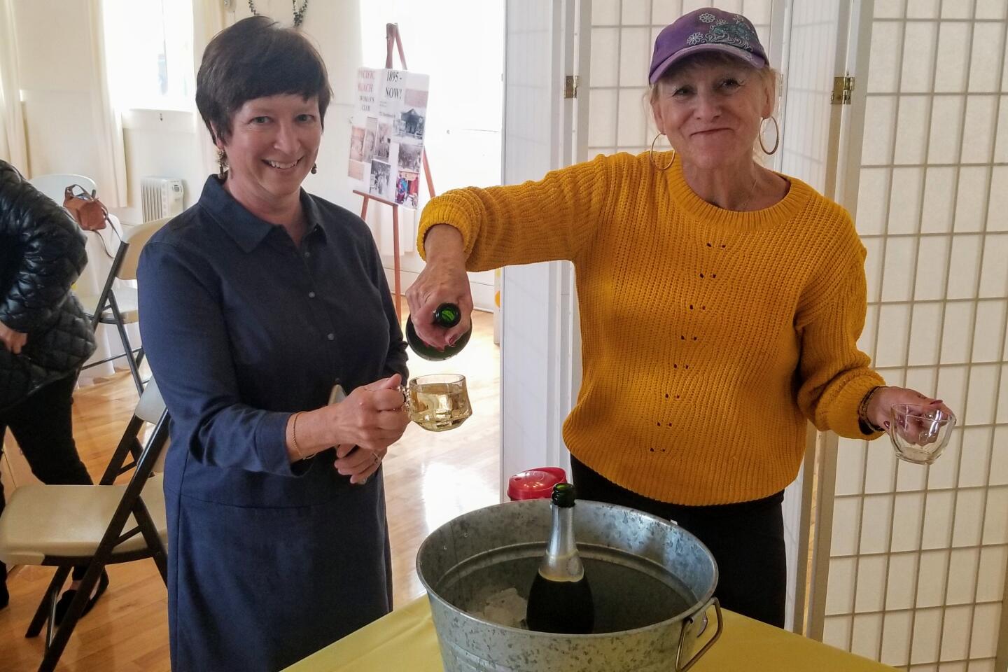 Liz Segre receives a glass of Champagne from past president of PB Woman’s Club Dianne Brittingham.