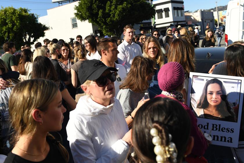 Los Angeles, California January 19, 2022: Mourners gather outside the Croft House Wednesday during a memorial for Brianna Kupfer who was stabbed to death inside the furniture store.. (Wally Skalij/Los Angeles Times)