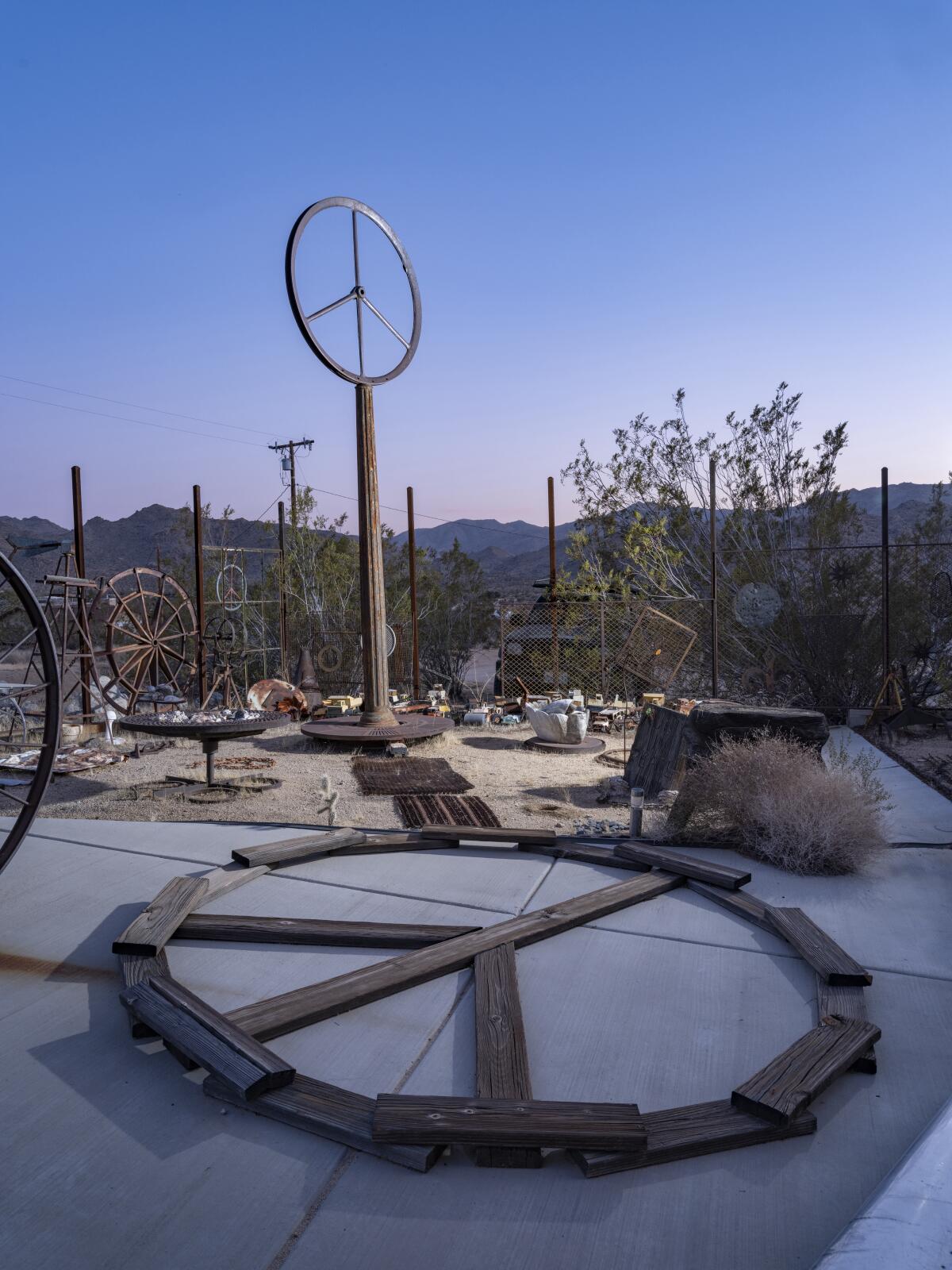 Peace signs and other art by Bobby Furst in a desert garden