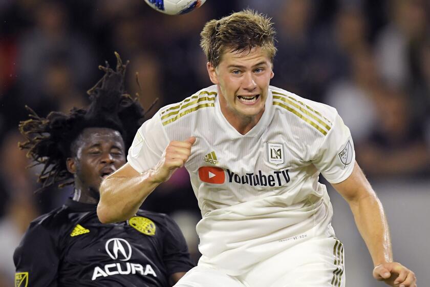 Los Angeles FC defender Walker Zimmerman, right, heads the ball in front of Columbus Crew defender Lalas Abubakar during the second half of an MLS soccer match Saturday, June 23, 2018, in Los Angeles. LAFC won 2-0. (AP Photo/Mark J. Terrill)