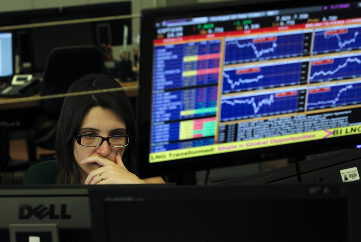 A broker works in a trading room of a Portuguese bank in Lisbon on Wednesday. The country's financial markets went into a steep nose dive during the day.