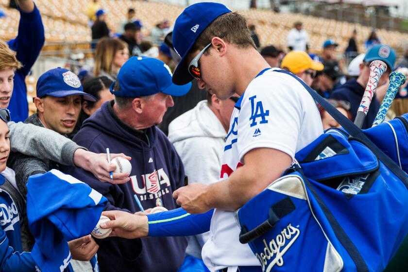 Joc Pederson signs autographs before a spring training earlier this week.