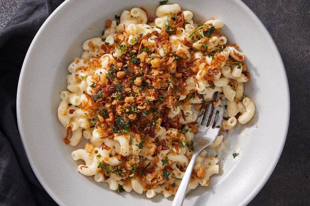A bowl of macaroni and cheese is topped with an all-purpose bread crumb topping, full of herbs and shallots.