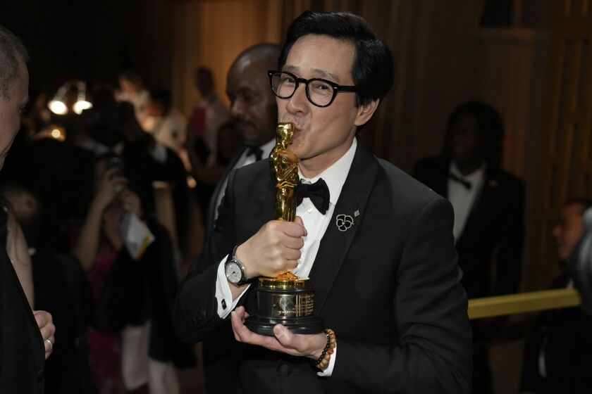 Ke Huy Quan kisses his award for best performance by an actor in a supporting role for "Everything Everywhere All at Once" at the Governors Ball after the Oscars on Sunday, March 12, 2023, at the Dolby Theatre in Los Angeles. (AP Photo/John Locher)