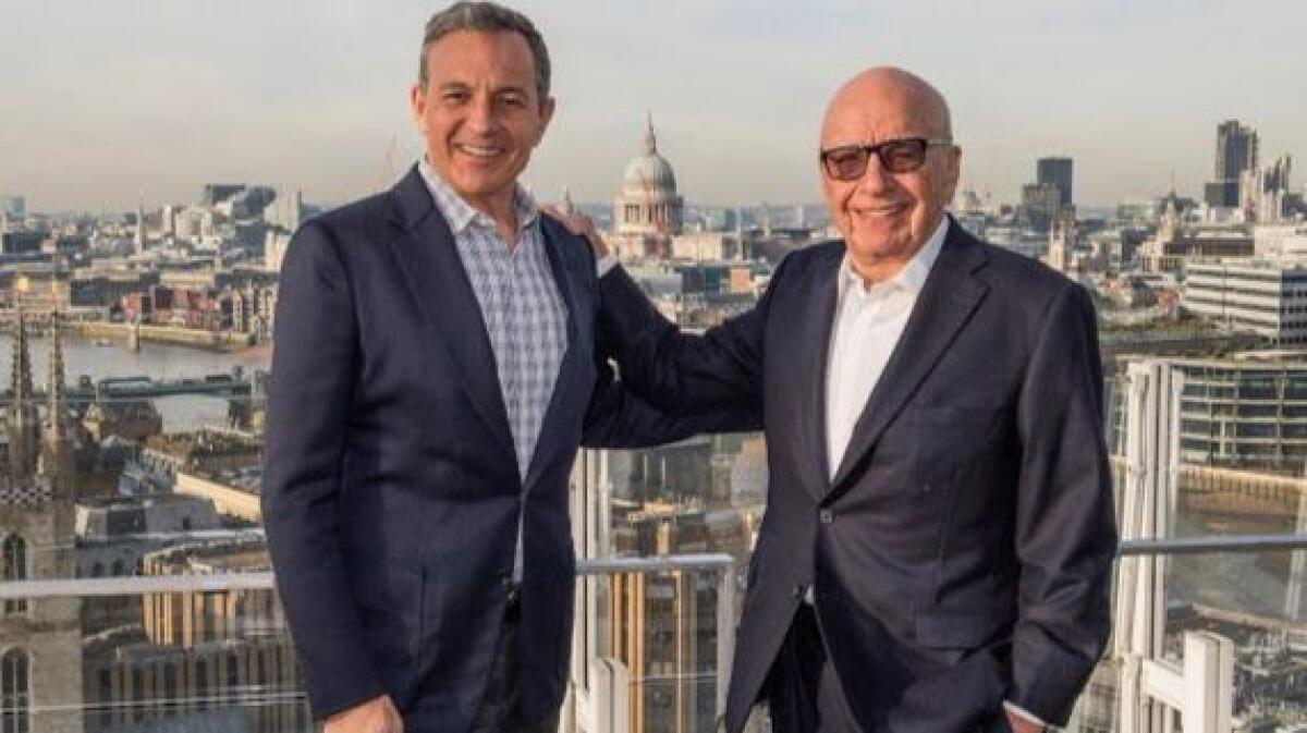 Walt Disney Co. CEO Bob Iger, left, and Fox Executive Chairman Rupert Murdoch in London celebrate Disney's initial bid in December to buy much of 21st Century Fox.