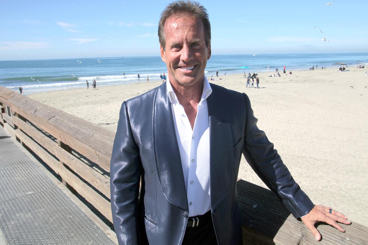 Tom Miller of Newport Beach on a pier overlooking the beach and ocean.
