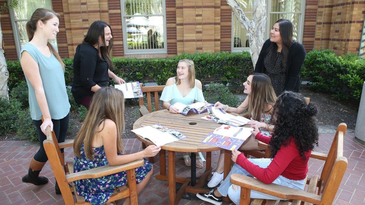Healthy Emotions & Attitudes in Relationships Today team members Molly Delbridge, left, Jennifer Ponce and Yanira Mendez chat with teen volunteers Chloe Green, Jillian Powell, Ashley Bussell and Melanie Ponce in the courtyard of Laura's House in Ladera Ranch.