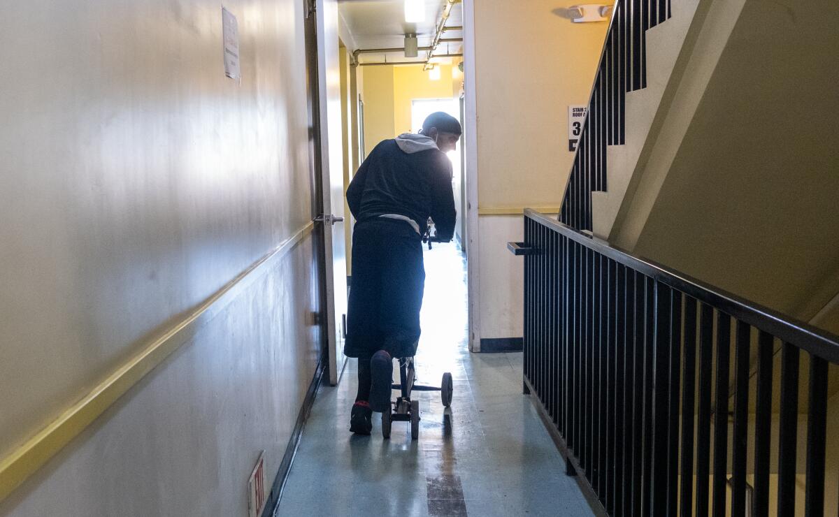 Marvin Danzey III uses a scooter to move through the hallway at the Lincoln Hotel in late September.