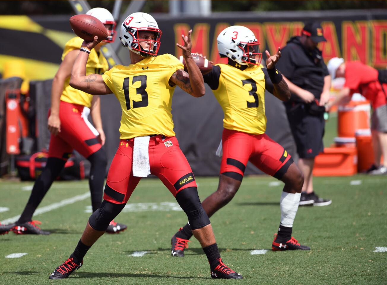 From left, Tyler DeSue and Tyrell Pigrome, University of Maryland QBs, during a passing drill during training camp on media day.