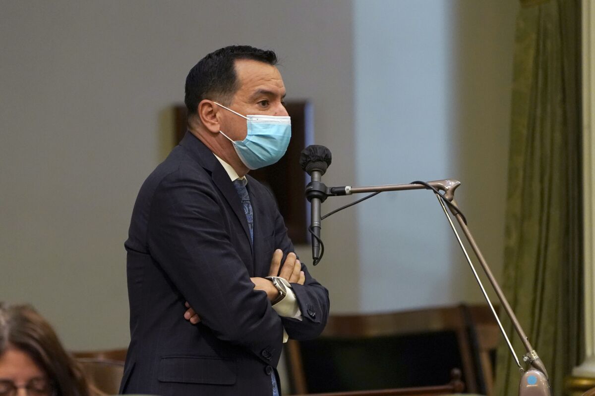 FILE - In this July 15, 2021, file photo, Assembly Speaker Anthony Rendon, D-Lakewood, wears a face mask as he addresses the Assembly in Sacramento, Calif. On Monday, Aug. 16, 2021, Rendon said all Assembly employees must be vaccinated against the coronavirus and must have begun the vaccination process by Sept. 1. Rendon said the move will protect everyone who enters the Capitol. (AP Photo/Rich Pedroncelli, File)