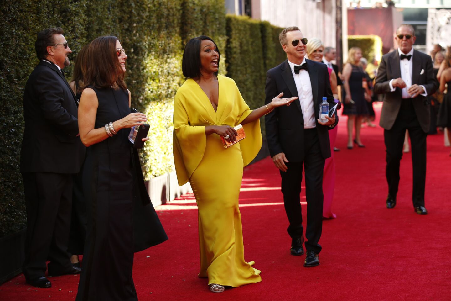 Angela Bassett arrives in a bright gown.