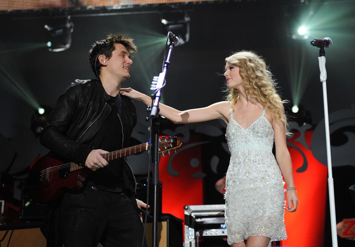 John Mayer and Taylor Swift perform onstage during Z100's Jingle Ball at Madison Square Garden on Dec. 11, 2009.