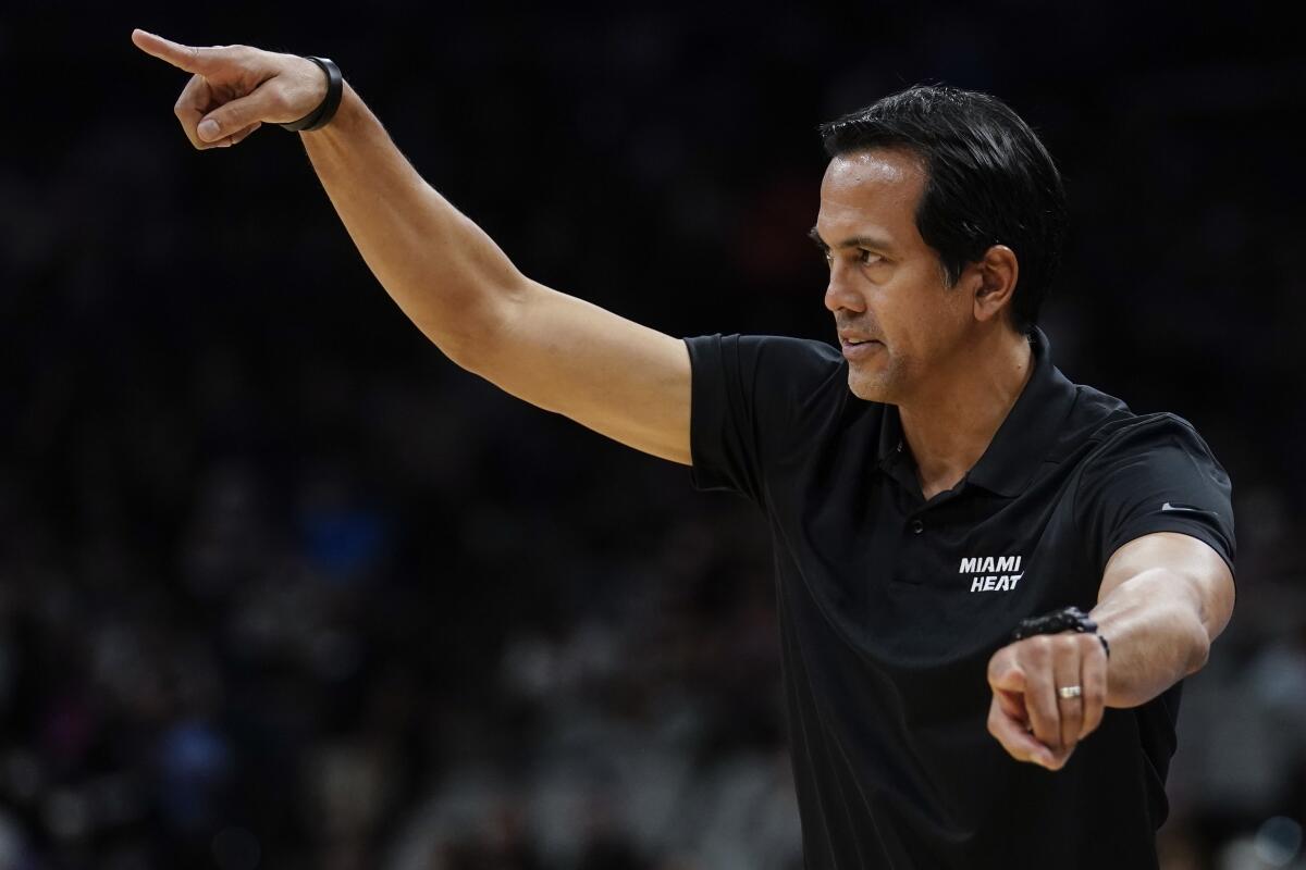 Miami Heat head coach Erik Spoelstra signals to his players during the first half of a preseason NBA basketball game against the San Antonio Spurs, Friday, Oct. 8, 2021, in San Antonio. (AP Photo/Darren Abate)