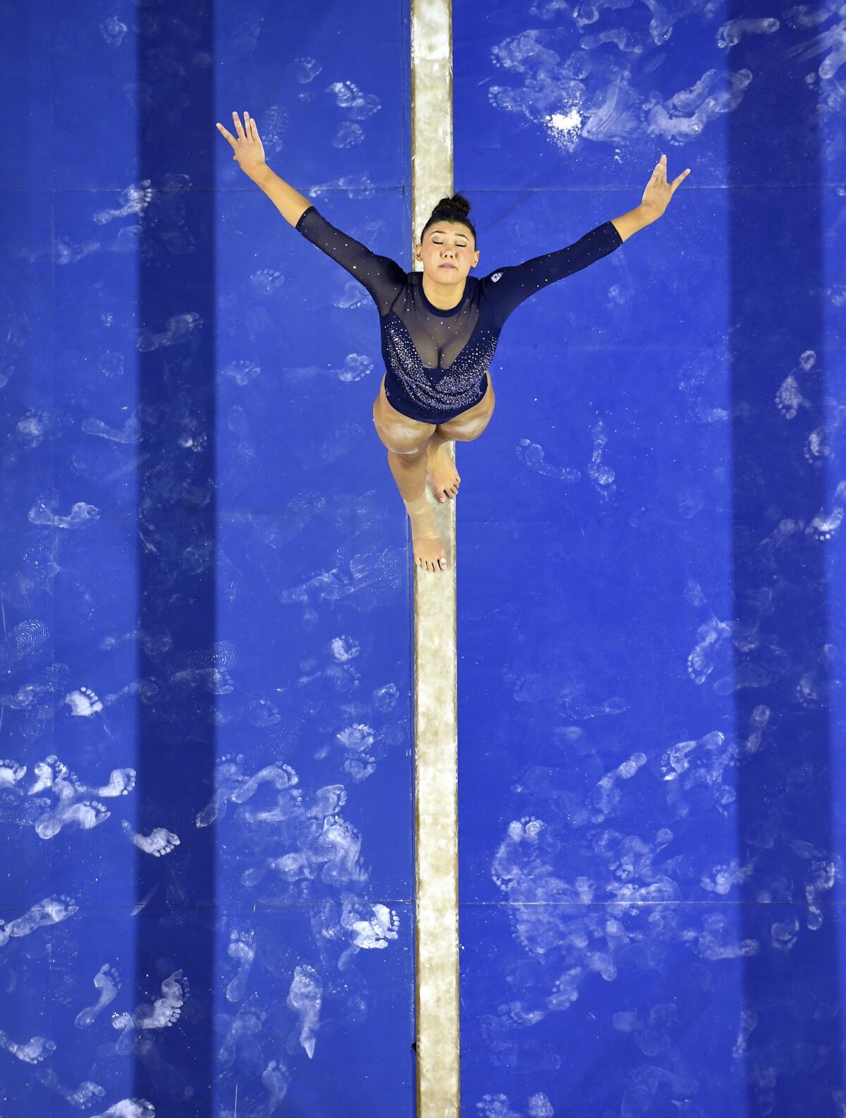 Kyla Ross competes on the beam for UCLA at Pauley Pavilion.