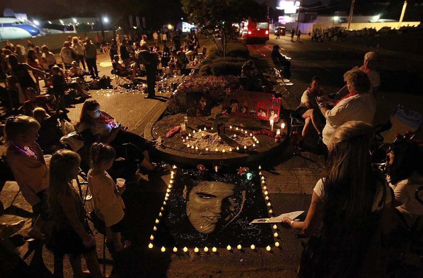 Fans create makeshift memorials to Elvis Presley on the street outside his mansion, Graceland. Elvis, known as the King of Rock 'n' Roll, died at Graceland on Aug. 16, 1977.
