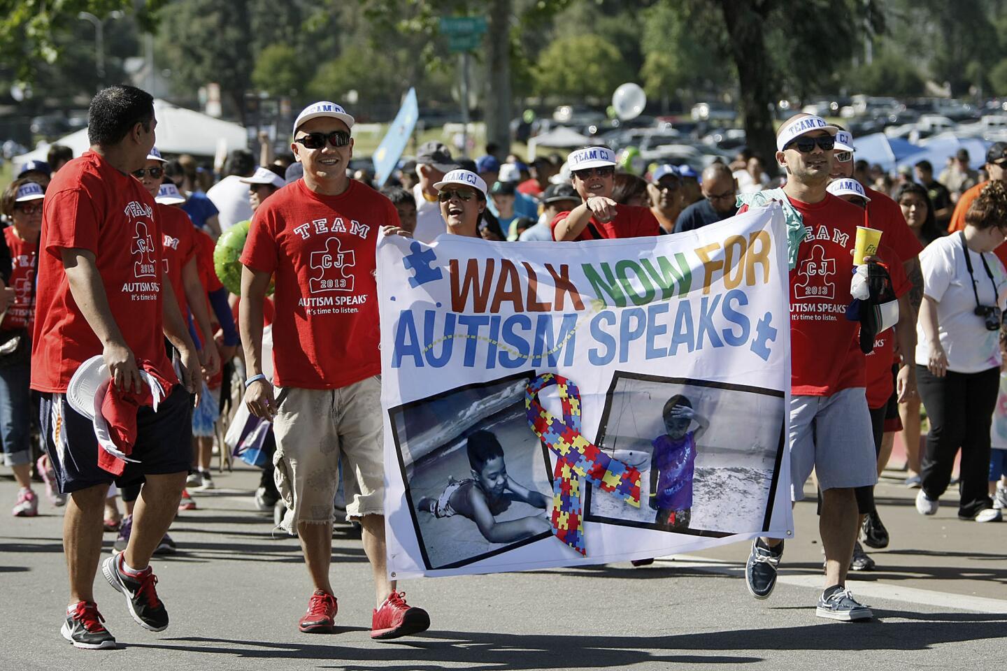 Team CJ 2013 members carried a large sign as they walked around the Rose Bowl during the 11th Annual Walk Now For Autism Speaks in Pasadena on Saturday, April 20, 2013. About 40,000 people were expected to participate in the fundraiser for autism research, advocacy and family services.