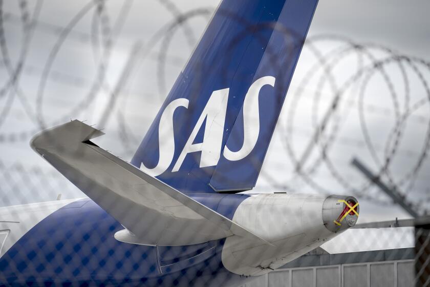 FILE - An SAS aircraft is parked on the ground during the pilot strike, at Copenhagen Airport, on July 18, 2022. Shares in Scandinavian Airlines dropped more than 90% on Wednesday Oct. 4, 2023 after the ailing carrier announced new shareholders in a restructuring scheme that will see the company delisted and existing ownership stakes erased. (Liselotte Sabroe/Ritzau Scanpix via AP, File)