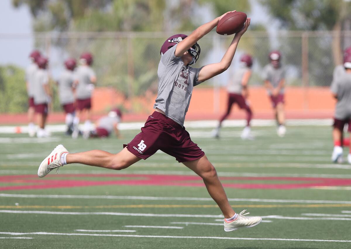 Jack Crawford makes a catch on the run during practice at Laguna Beach on Aug. 2.
