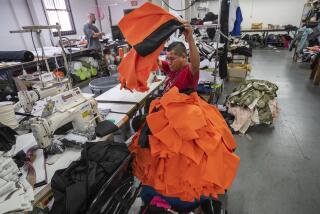 LOS ANGELES, CA-OCTOBER 10, 2019: A member of the production team (didn’t want to give his name) places another jacket onto a pile after sewing the lining, while working inside the manufacturing department where Designer Daniel Patrick’s clothes are made on San Pedro St. in downtown Los Angeles. (Mel Melcon/Los Angeles Times)