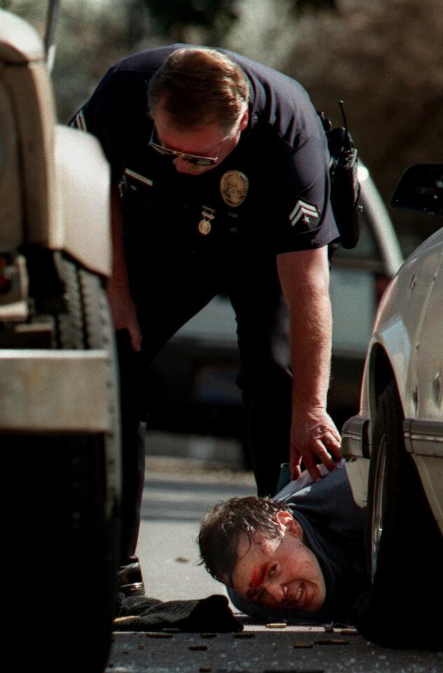 One of the suspects in the North Hollywood bank heist and shootout of 1997 lies wounded on the ground after being shot by police. He later died.