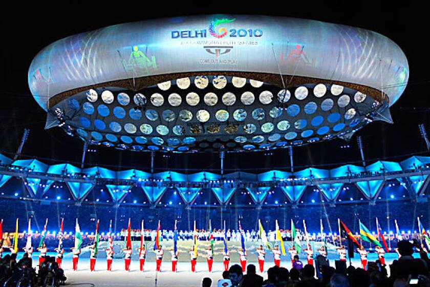 A giant tethered "aerostat" balloon bearing the Delhi 2010 logo hovers over Jawaharlal Nehru stadium in New Delhi.