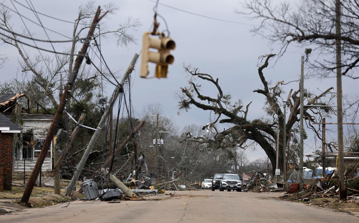 Cars carefully navigate downed trees and power lines in Selma.