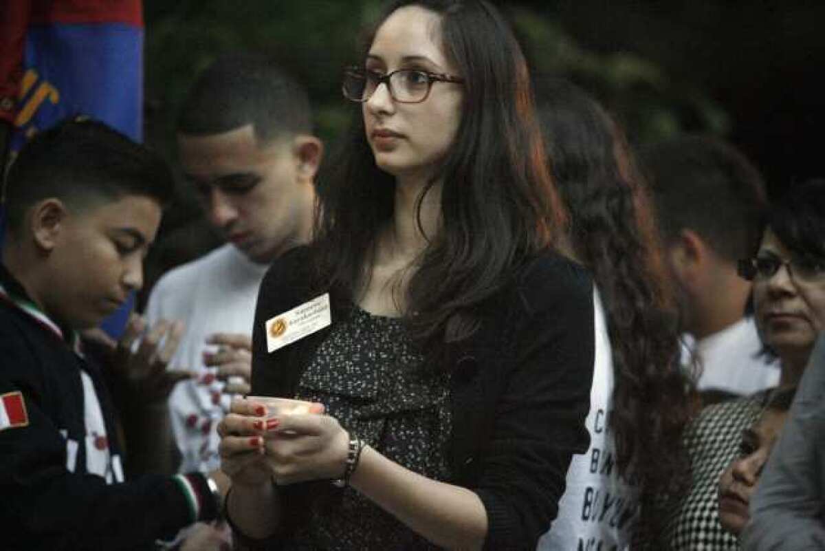 Nareene Karakashian lights a candle to commemorate the lives that were lost during the Armenian genocide at a memorial at Burbank City Hall.
