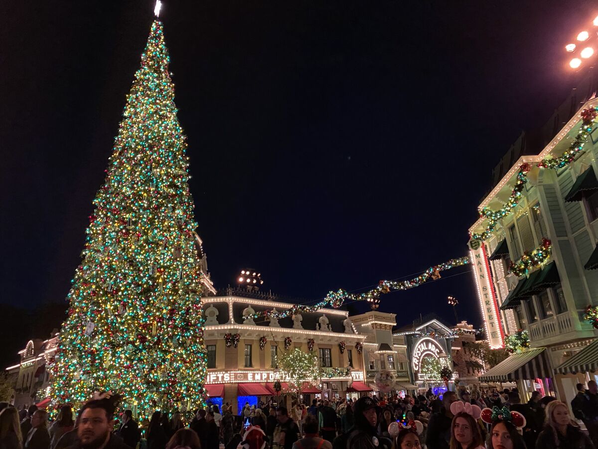 The festive holiday décor at Disneyland includes a 60-foot-tall Christmas tree on Main Street, USA.