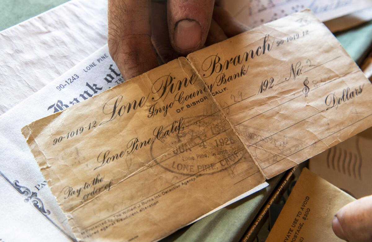 A creased paper check, yellowed with age, drawn on the Lone Pine Branch of Inyo County Bank and stamped June 4, 1926