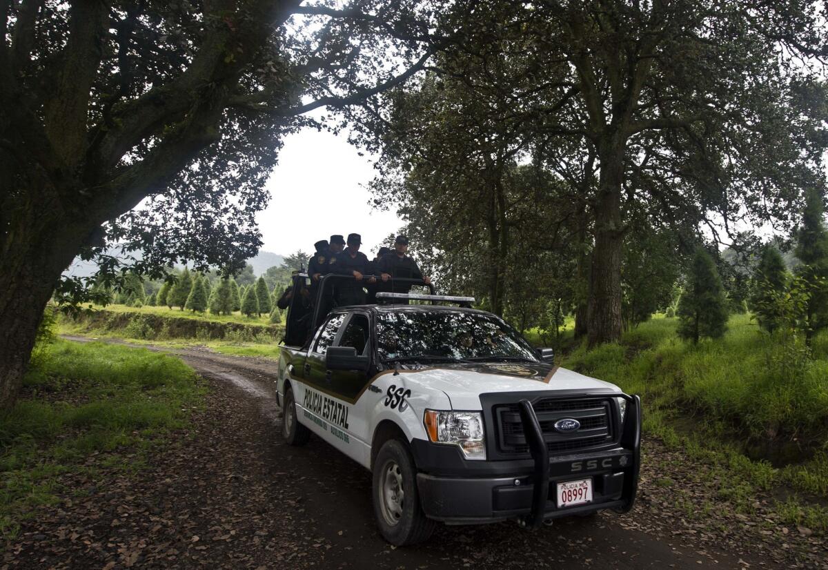 Mexican police officers are seen patrolling rural tracks near a park in the municipality of Tlalmanalco near Mexico City. Mexican authorities acknowledged this week that they will miss another deadline for vetting the nation's federal, state and local police officers.
