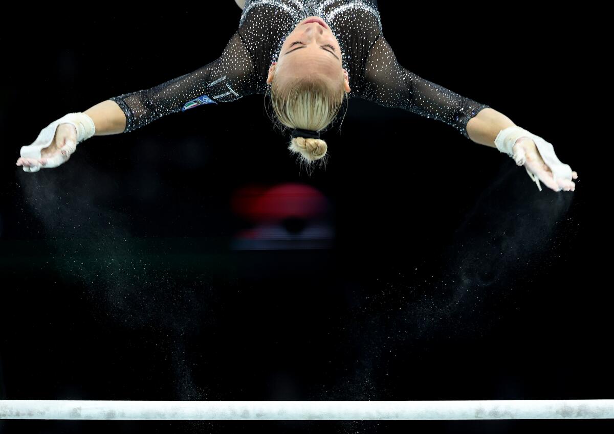 Italy's Alice D'Amato competes on the uneven bars during qualifying for women's team gymnastics at the Olympics in Paris.