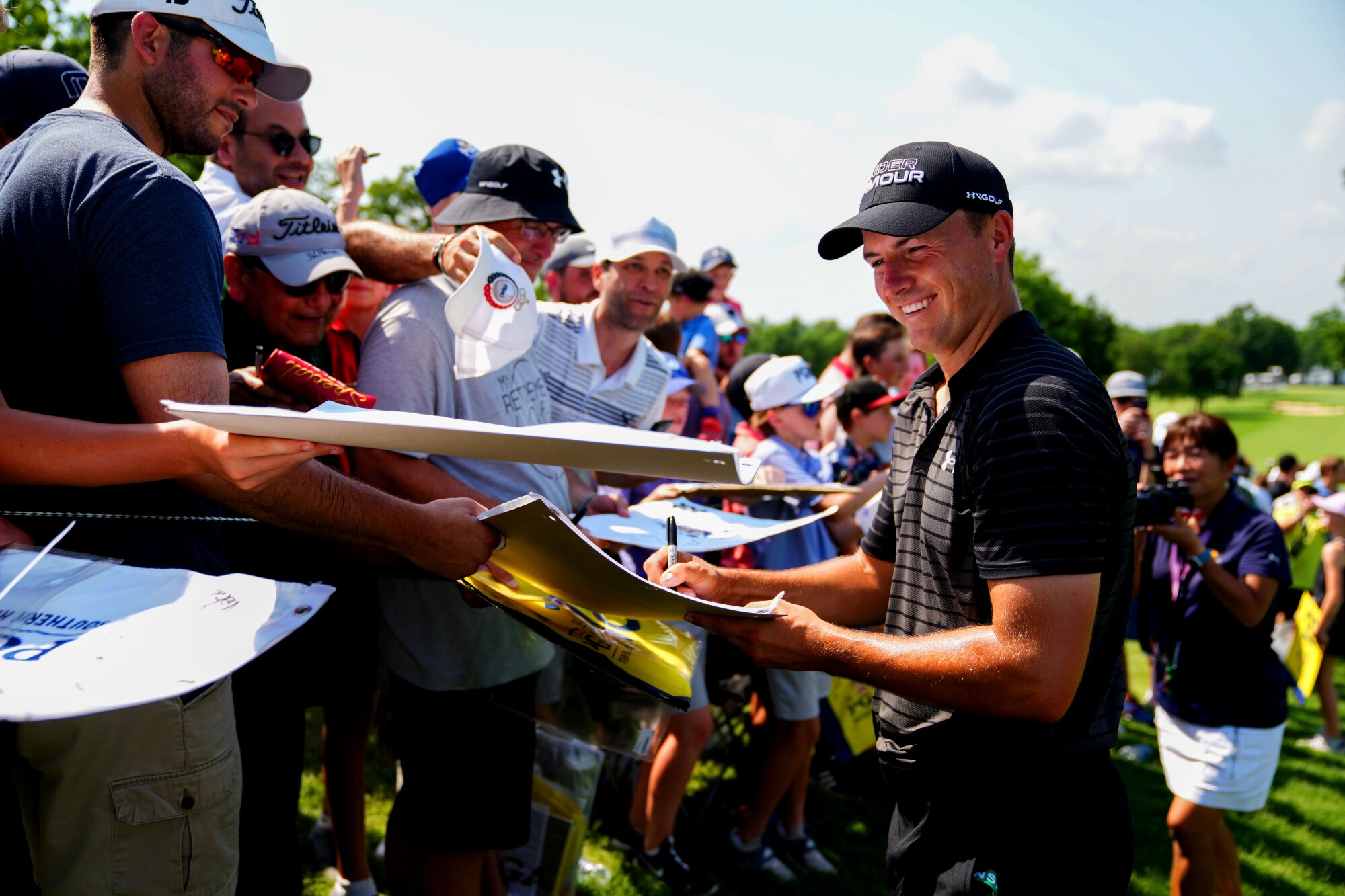 Jordan Spieth signs autographs at the 2022 PGA Championship.