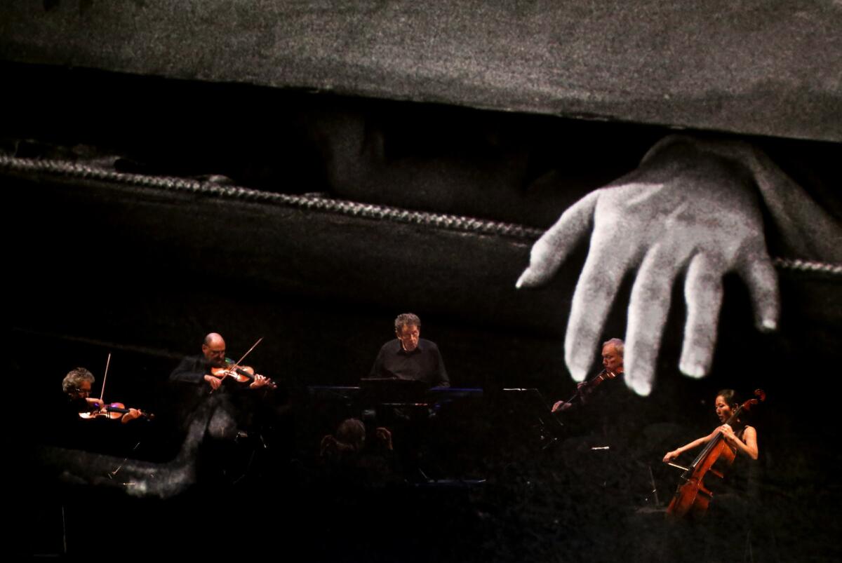 Philip Glass, center, and the Kronos Quartet perform at a screening of Dracula in 2015.