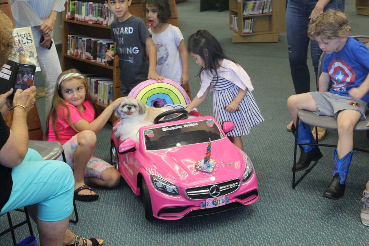 Cupcake meets fans at the library.