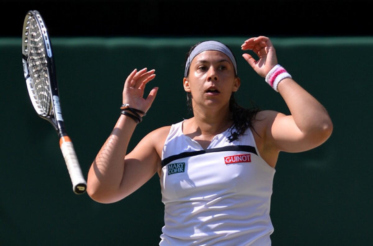 Marion Bartoli of France drops her racket after serving an ace on match point to defeat Sabine Lisicki of Germany in the women's championship match at Wimbledon on Saturday.