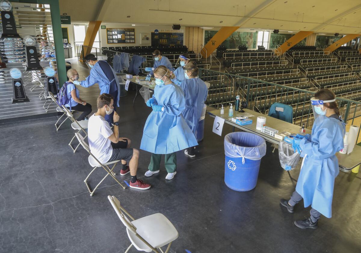 Nursing students administer COVID-19 tests to students at Point Loma Nazarene University in San Diego on Thursday.