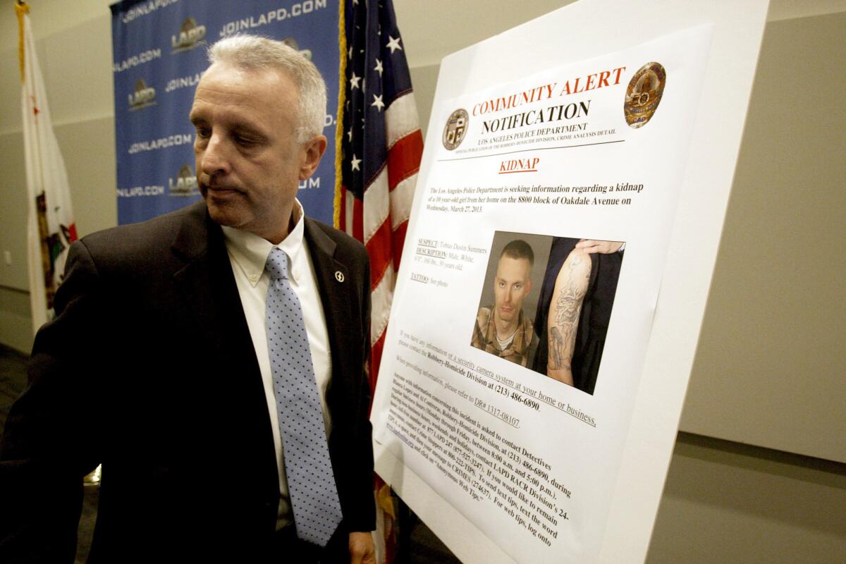 Los Angeles Police Lt. Walter Teague is shown at LAPD headquarters with a poster seeking the public's help in locating Tobias Dustin Summers, the prime suspect in the kidnapping and sexual assault of a 10-year-old girl.