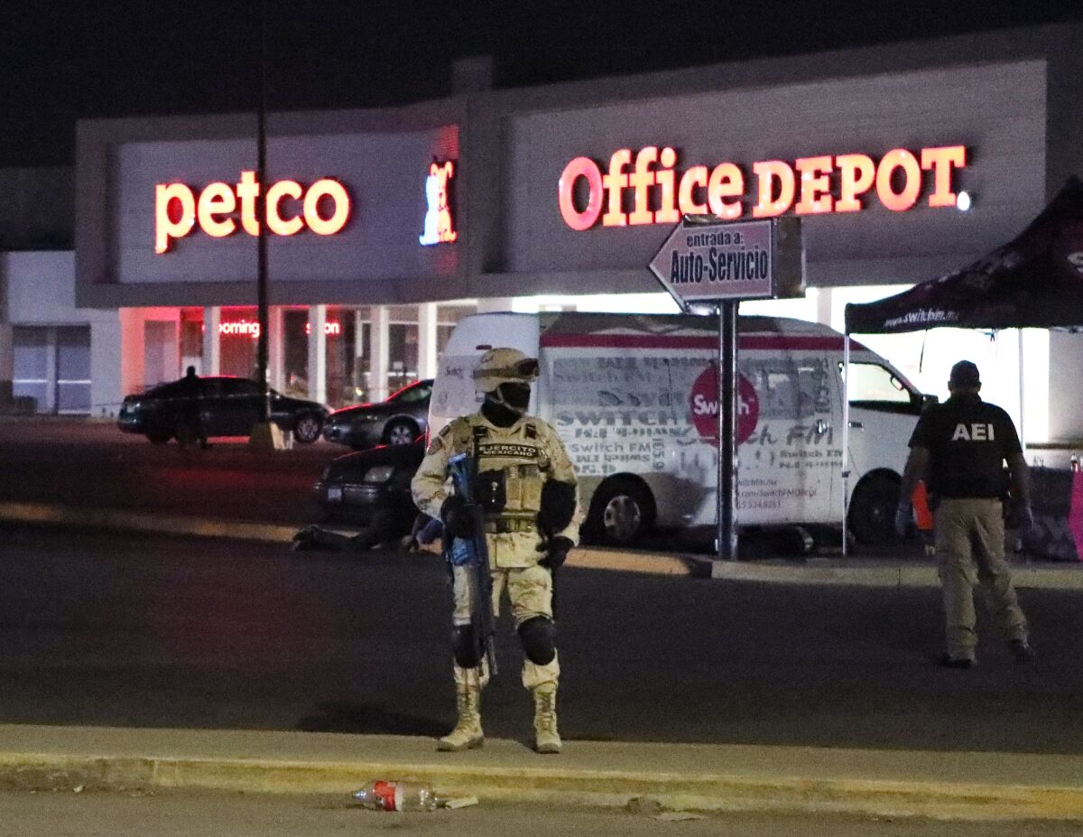 Officer stand guard in front of stores.