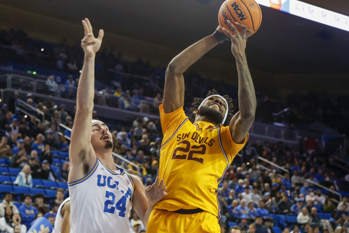 Arizona State forward Warren Washington, right, shoots in front of UCLA guard Jaime Jaquez Jr. during the first half.