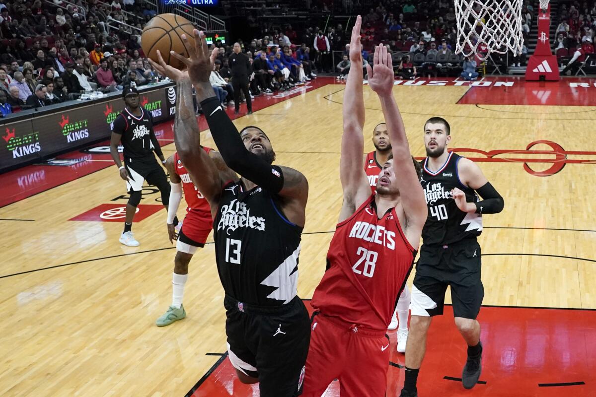 The Clippers' Paul George shoots over Houston Rockets center Alperen Sengun.