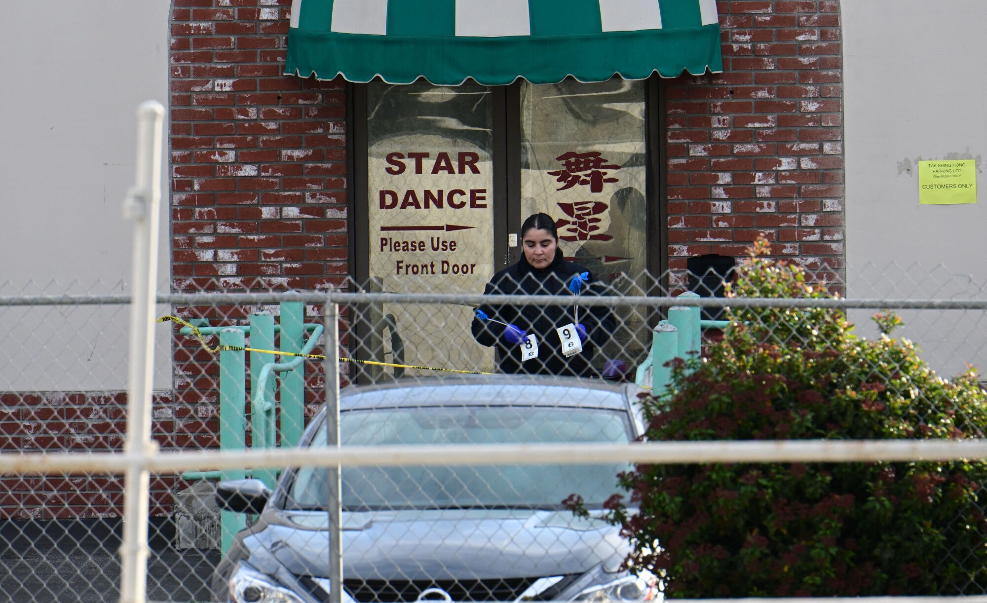 An investigator at a door reading Star Dance.