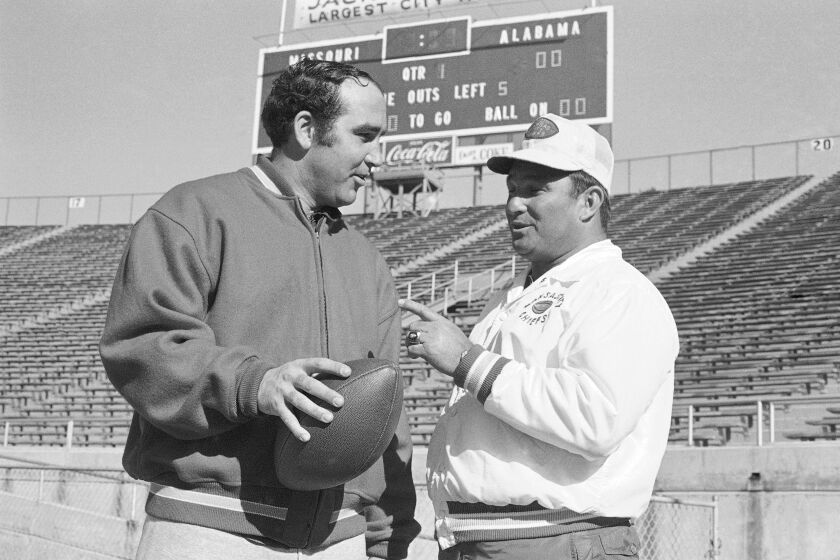 FILE - San Diego Chargers quarterback John Hadl gets instructions from West coach Hank Stram, as the team prepared to meet the East in an American Football League game, Jan. 19, 1969, in Jacksonville, Fla. Longtime NFL quarterback John Hadl, who starred for his hometown Kansas Jayhawks before embarking on a professional career that included six Pro Bowl appearances and an All-Pro nod, died Wednesday, Nov. 30, 2022. He was 82. The university, where Hadl returned after his playing days as a coach and fundraiser, announced his death at the wishes of his family in a statement. No cause was given. (AP Photo/File)