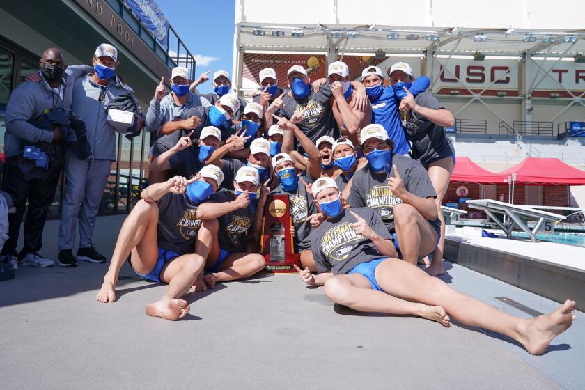 Members of the UCLA men's water polo team celebrate after winning the NCAA championship with a 7-6 victory over USC on March 21, 2021. (Catharyn Hayne)